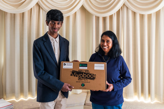 Clarence handing over the laptop to Dharma Foundation