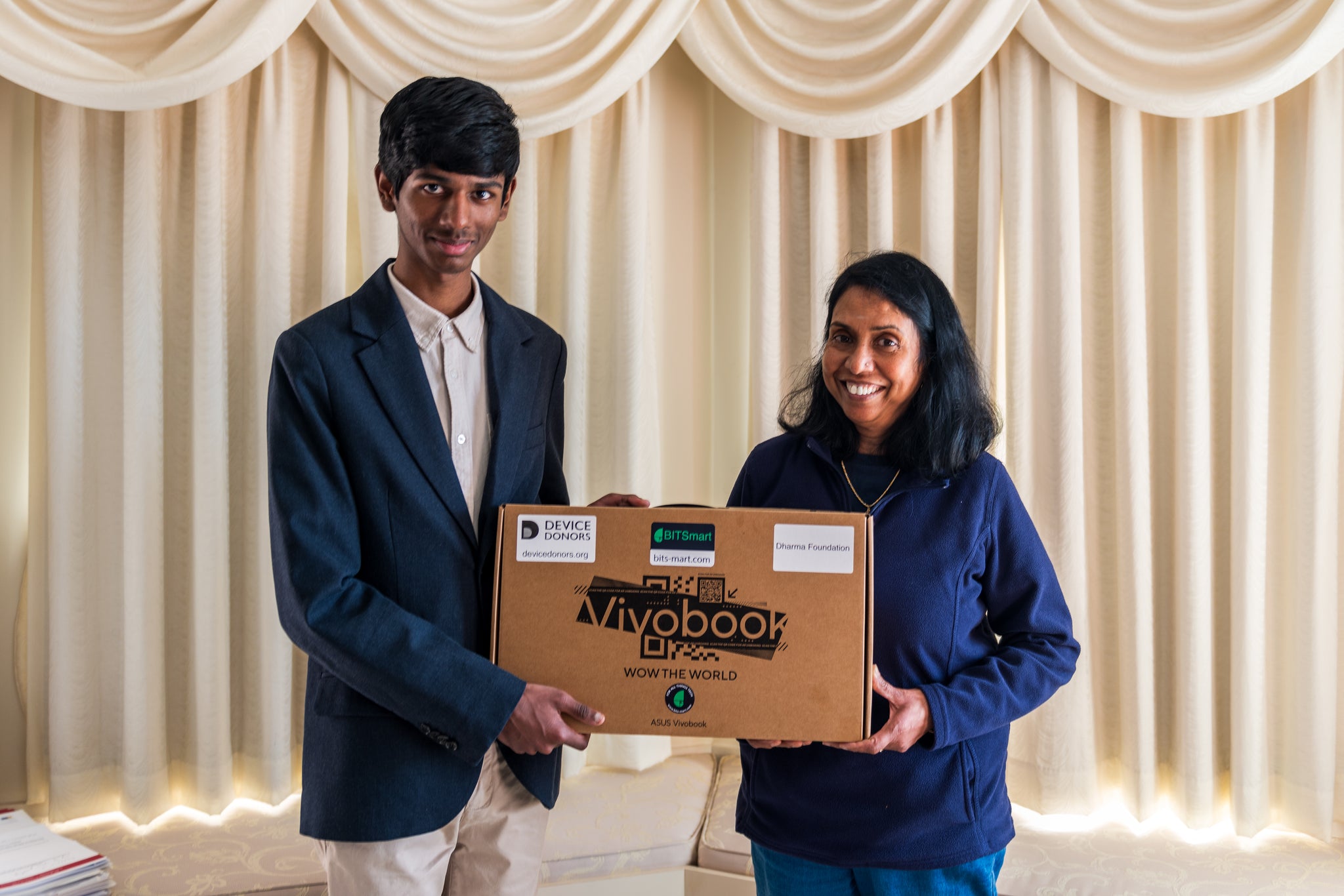 Clarence handing over the laptop to Dharma Foundation